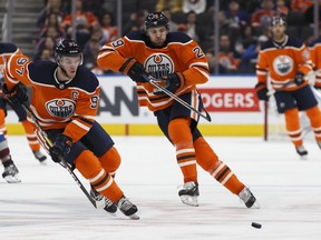 Connor McDavid (left) and Leon Draisaitl began the Oilers' opener on different lines, but were re-united later on and keyed a comeback win over the Canucks. Ian Kucerak/Postmedia