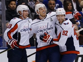 Capitals defenceman John Carlson (centre) celebrates with forward Nicklas Backstrom (left) and forward Evgeny Kuznetsov (right) after scoring his second goal of the game against the Maple Leafs during the second period at Scotiabank Arena in Toronto, on Tuesday, Oct. 29, 2019.