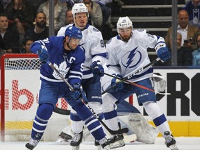 Maple Leafs captain John Tavares, left, gets set to tip in his first goal of the season against the Lightning during first period NHL action at Scotiabank Arena in Toronto, on Thursday, Oct. 10, 2019.