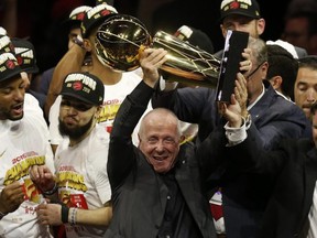 Raptors part-owner Larry Tanenbaum holds up the Larry OBrien Trophy after Toronto beat the Golden State Warriors in the NBA Finals.