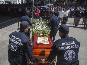 Relatives and members of the police department of Michoacan pay tribute to the officers killed in an ambush in Morelia, in the Mexican state of Michoacan, on October 15, 2019.