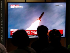People watch a TV broadcast showing a file footage for a news report on North Korea firing two projectiles, possibly missiles, into the sea between the Korean peninsula and Japan, in Seoul, South Korea, Oct. 31, 2019.