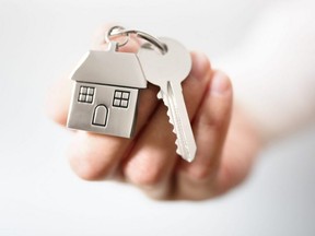 Real estate agent gives keys to a new home.