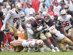 Washington Redskins running back Wendell Smallwood is brought down by the San Francisco defence at FedEx Field in Landover, Md., yesterday. 
Once again, the 49ers relied on their strong defence in their 9-0 shutout win against the Redskins. San Francisco is now 6-0. (USA Today)