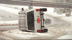 A crashed Jeep SUV with diplomatic plates on its side on Brookfield Rd. in Ottawa