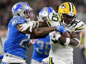 Jamaal Williams of the Green Bay Packers runs against Darius Slay of the Detroit Lions at Lambeau Field on October 14, 2019 in Green Bay. (Quinn Harris/Getty Images)