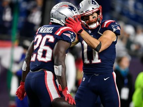New England Patriots wide receiver Julian Edelman, right, hugs running back Sony Michel after a run against the New York Giants during the second half at Gillette Stadium, Oct. 10, 2019.  (Bob DeChiara-USA TODAY Sports)
