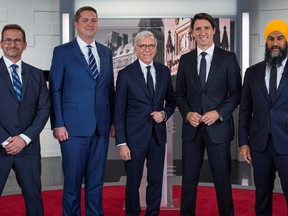 Left to right: Bloc Quebecois leader Yves-Francois Blanchet, Conservative leader Andrew Scheer, TVA network host Pierre Bruneau, Liberal leader and Prime Minister Justin Trudeau and NDP leader Jagmeet Singh pose before a French language debate for the 2019 federal election at TVA studios in Montreal, Oct. 2, 2019.   Joel Lemay/Pool via REUTERS/File Photo