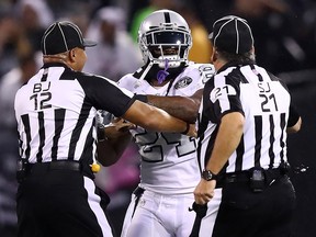 Marshawn Lynch of the Oakland Raiders is restrained after coming off the bench and shoving a referee during a scrum with the Kansas City Chiefs at Oakland-Alameda County Coliseum on October 19, 2017. (Ezra Shaw/Getty Images)