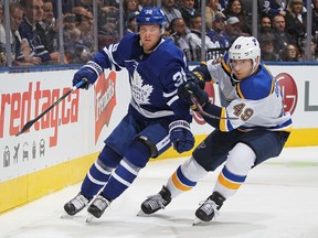 Maple Leafs defenceman Rasmus Sandin (left) and Blues’ Ivan Barbashev battle along the boards earlier this month. Sandin was sent down to the Marlies after opening the season with the Leafs. He is eager to return, and stay in, the NHL. (GETTY IMAGES)