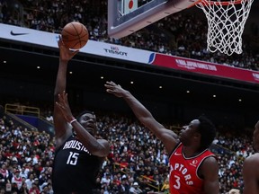 OG Anunoby of the Raptors attempts to prevent Clint Capela of the Houston Rockets from scoring yesterday during a preseason game in Japan on Oct. 10, 2019.  (TAKASHI AOYAMA/Getty Images)