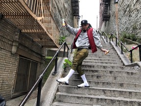 Jay Garcia, a radio host from Queens, dances down the “Joker Steps” in the Bronx borough of New York October 16, 2019. REUTERS/Isabella Jibilian
