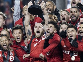 Toronto FC captain Michael Bradley (centre) hoists the MLS Cup back in 2017. The Reds must beat Atlanta United Wednesday night in order to get another crack at wining a championship.  Craig Robertson/Toronto Sun