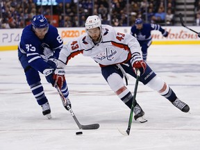 Capitals' Tom Wilson (43) controls the puck against Maple Leafs' Cody Ceci on Tuesday night in Toronto. (USA TODAY SPORTS)