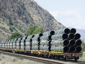 Pipes destined for the Trans Mountain pipeline are transported by rail through Kamloops, B.C., on June 25, 2019.