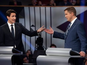 Conservative Leader Andrew Scheer (right) and Liberal Leader Justin Trudeau gesture to each other as they both respond during the Federal Leaders Debate at the Canadian Museum of History in Gatineau, Que., on Monday, Oct. 7, 2019.