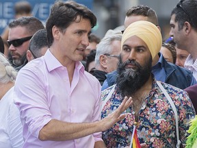Prime Minister Justin Trudeau, left, attends the annual pride parade with NDP leader Jagmeet Singh in Montreal, Sunday, August 18, 2019. (THE CANADIAN PRESS/Graham Hughes)