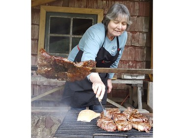 Maria Elena cooks up steaks at the Los Copihues restaurant in Chile on Saturday September 7, 2019. Veronica Henri/Toronto Sun/Postmedia Network