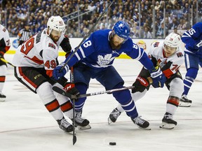 Maple Leafs' Jake Muzzin during first-period action in the team's home opener  against the Ottawa Senators. Sens' Scott Sabourin (left) and Mark Borowiecki are giving chase. (Ernest Doroszuk/Toronto Sun)