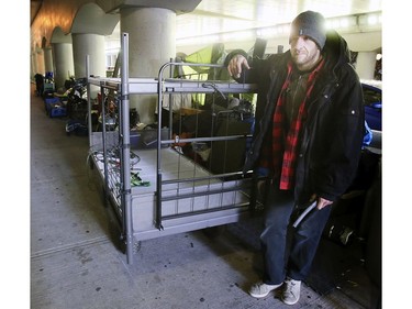 " Chris" stands next to his cart that he will fill with the belongings he wishes to take with him on Lower Simcoe Street in Toronto on Friday, October 4, 2019.City workers served eviction notices to those living there. Veronica Henri/Toronto Sun/Postmedia Network
