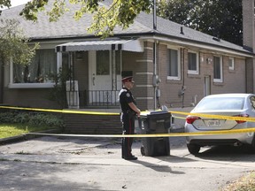 A Toronto Police officer guards the front of 64 Birkdale Rd. in Scarborough after a woman was stabbed on Thursday October 10, 2019
