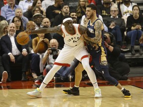 Toronto Raptors Pascal Siakam, left, looks to get past New Orleans Pelicans Lonzo Ball during the second quarter in Toronto, Oct. 22, 2019. (Jack Boland/Toronto Sun/Postmedia Network)