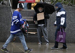 Peter Anthony experiences what it is like to be a panhandler on Yonge St., in Toronto on Wednesday, October 30, 2019. Veronica Henri/Toronto Sun/Postmedia Network