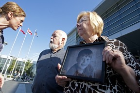Mitchell Wilson’s grandmother Pam Wilson hold a photo of Mitchell with grandfather Bob on left outside of court on Sept. 28, 2011.