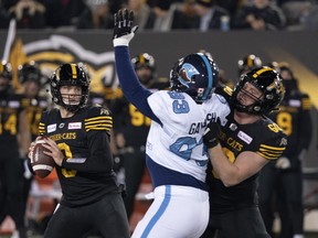 Hamilton Tiger-Cats quarterback Hayden Moore throws under pressure during Saturday's game against the Toronto Argonauts. (THE CANADIAN PRESS)