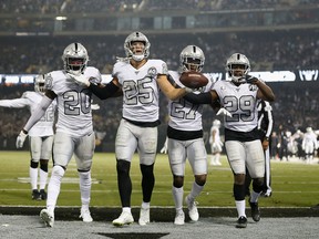 Erik Harris #25 of the Oakland Raiders celebrates with teammates after intercepting a pass by Philip Rivers of the Los Angeles Chargers on Thursday. (GETTY IMAGES)