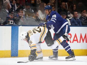Jason Spezza of the Toronto Maple Leafs checks Par Lindholm of the Boston Bruins during the first period at the Scotiabank Arena on Saturday night. Bruce Bennett/Getty Images
