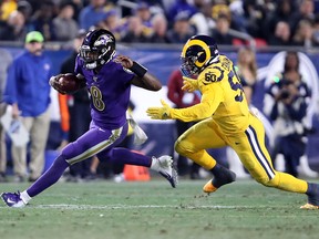 Ravens quarterback Lamar Jackson eludes the defence of the Rams’ Samson Ebukam on Monday night. Jackson threw for five touchdowns and ran for 95 yards in the Ravens’ 45-6 victory.  Getty IMages