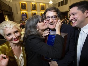 Toronto Sun Columnist Lorrie Goldstein gets a kiss from his wife, Krys, while posing with his son, Alan Goldstein, and Leah Faye. Goldstein was inducted into the Canadian News Hall of Fame on Nov. 19, 2019. (Stan Behal, Toronto Sun)