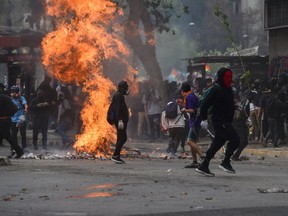 People demonstrate against the economic policies of the government of President Sebastian Pinera, in Santiago, on Nov. 4, 2019.  (Rodrigo Aramgua/AFP via Getty Images)