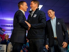 Peter MacKay (left) shakes hands with Conservative Leader Andrew Scheer while campaigning a few days before the Oct. 21 election in Little Harbour, N.S. (Reuters)