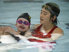 Six-year old Madi Ambos swims with Variety Village training staff on Nov. 15, 2019. Jack Boland/Toronto Sun