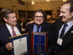 The Toronto Sun’s Lorrie Goldstein with Mayor John Tory (left) and Ed Patrick, president of the Toronto Press and Media Club (right). Goldstein was inducted into the Canadian News Hall of Fame on Nov. 19, 2019. (Stan Behal, Toronto Sun)