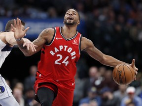 Dallas Mavericks centre Maxi Kleber, left, grabs Toronto Raptors guard Norman Powell as Powell advances the ball upcourt in the first half of an NBA basketball game in Dallas, Saturday, Nov. 16, 2019. (AP Photo/Tony Gutierrez)