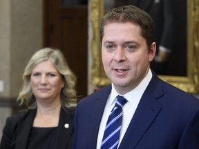Conservative Deputy Leader Leona Alleslev listens as Andrew Scheer speaks with the media in the foyer of the House of Commons in West Block, Thursday November 28, 2019 in Ottawa. THE CANADIAN PRESS/Adrian Wyld