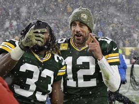 Aaron Rodgers (right) and Aaron Jones celebrate a win earlier this season. (GETTY IMAGES)