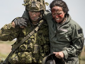 Members of Task Force Tomahawk from 2 Combat Engineer Regiment and the 1st and 3rd Battalions of The Royal Canadian Regiment respond to a CH-147F Chinook helicopter crash simulation during Exercise MAPLE RESOLVE, the largest and most comprehensive Canadian Army training event of the year, held in Wainwright, Alberta on May 19, 2017.  Photo: Cpl Andrew Wesley, Directorate of Army Public Affairs LF03-2017-0071-014