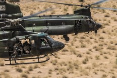 An RCAF Griffon CH-146 and a Chinook CH-147F fly in formation on operations over Mali. 5 June 2019.