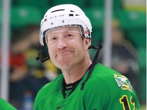 Former NHL player Mike Commodore smiles with teammates before a fundraising hockey game at the Parson Centennial Arena in Okotoks on Sunday afternoon April 15, 2018.