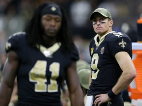 New Orleans Saints quarterback Drew Brees (9) looks on from the bench in the second half  against the Atlanta Falcons at the Mercedes-Benz Superdome. Saints running back Alvin Kamara (41) is at left. : Chuck Cook-USA TODAY Sports ORG