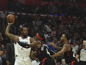 LA Clippers forward Kawhi Leonard (2) looks to pass the ball defended by Toronto Raptors forward Rondae Hollis-Jefferson (4) and guard Norman Powell (24) during the first half at Staples Center: Richard Mackson-USA TODAY Sports
