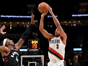 Nov 13, 2019; Portland, OR, USA; Portland Trail Blazers guard CJ McCollum (3) makes a basket over Toronto Raptors forward Rondae Hollis-Jefferson (4) during the second half at Moda Center. The Raptors won 114-106. Mandatory Credit: Steve Dykes-USA TODAY Sports ORG XMIT: USATSI-406877