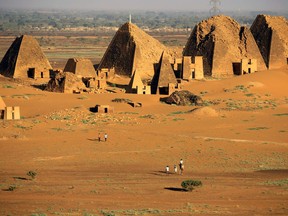 Tourists walks to the Royal Cemeteries of Meroe Pyramids in Begrawiya at River Nile State, Sudan November 10, 2019.  REUTERS/Mohamed Nureldin Abdallah