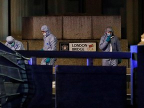 Forensics officers are seen near the site of an incident at London Bridge in London, Britain, November 29, 2019. REUTERS/Peter Nicholls
