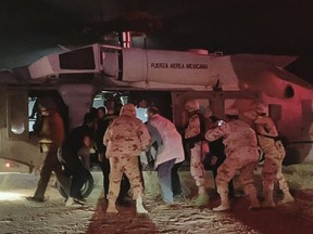 Handout picture released by the Health Secretary of Sonora state press office showing Medical personnel of the Health Secretary and of the Mexican Air Force transfering five members of the Lebaron family after being injured during an gunmen ambush in the limits of Sonora and Chihuahua in Hermosillo, Mexico, on November 5, 2019.