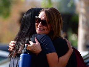 Women embrace in Central Park after a shooting at Saugus High School in Santa Clarita, California on November 14, 2019. (Photo by FREDERIC J. BROWN/AFP via Getty Images)